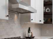 Victory Twister 36 Inch Wall Mount Range Hood installed in a white kitchen with stainless steel baffle filters and LED lighting