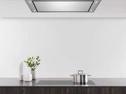 Flush stainless steel Horizon unit integrated into a modern kitchen ceiling above a cooktop.