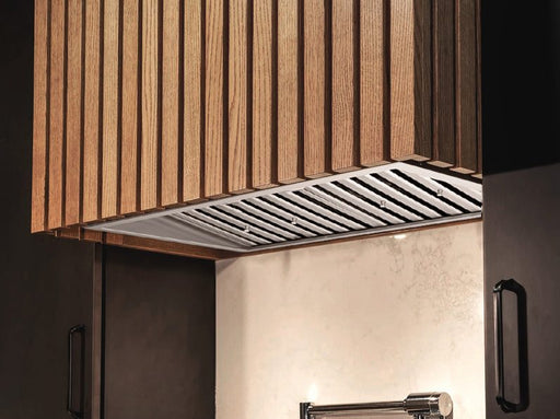 Victory Q2 30 Inch Range Hood Insert installed in custom wood cabinetry with stainless steel baffle filters