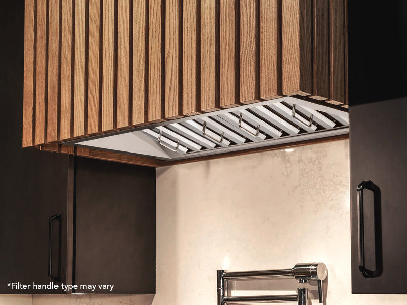 Lifestyle view of the 36 Inch 700 CFM Range Hood Insert - VICTORY Q2 installed in a custom wood cabinet, highlighting its slim profile and baffle filters