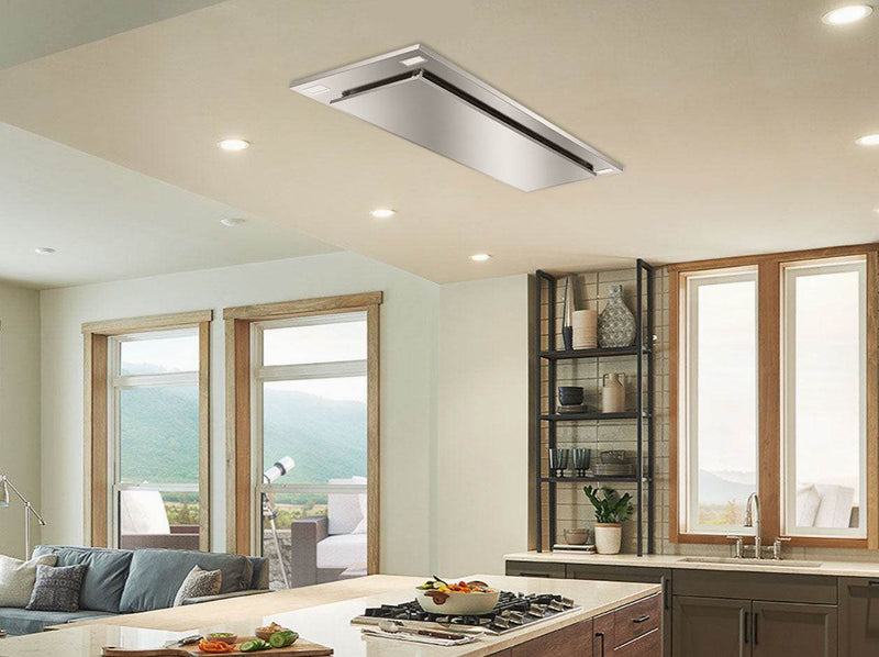 Stainless steel wireless flush ceiling mount range hood installed above an island in a modern open concept kitchen