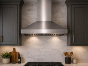 36 Inch Wall Mount Range Hood Victory Twister installed between dark kitchen cabinets above a gas cooktop with stainless chimney, baffle filters, and LED lighting