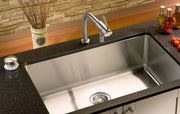 Top-down view of a rectangular stainless steel sink bottom protector grid featuring a center drain cutout and black protective rubber bumpers.
